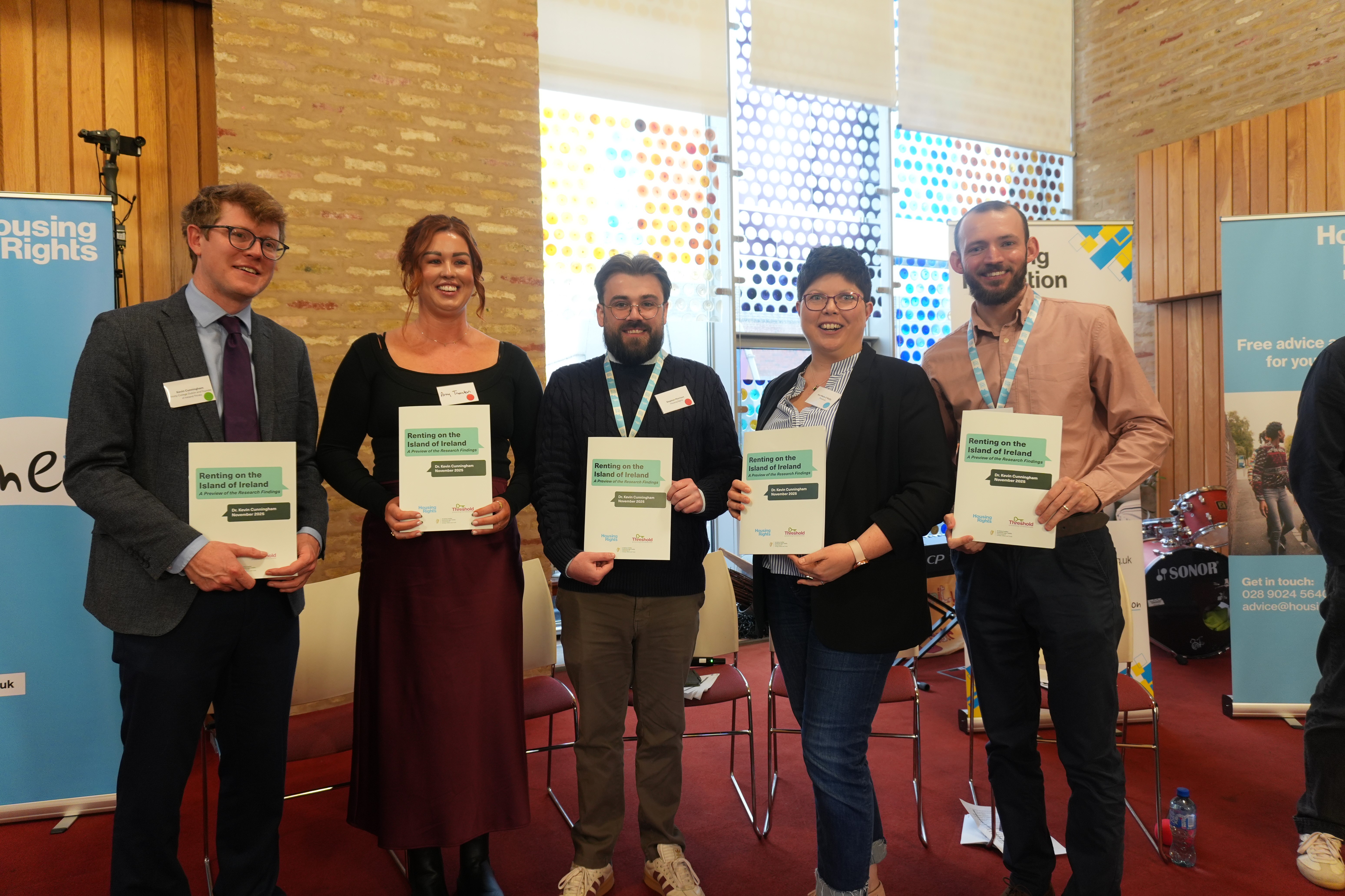 Dr Kevin Cunnigham, Amy Thornton, Ann-Marie O'Reilly, Jamie Miller holding the summarised report on experience of private renters on the island of Ireland