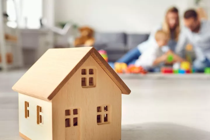 Wooden house with family in background