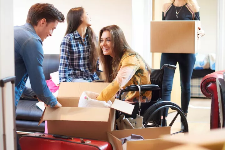 Students unpacking in living space