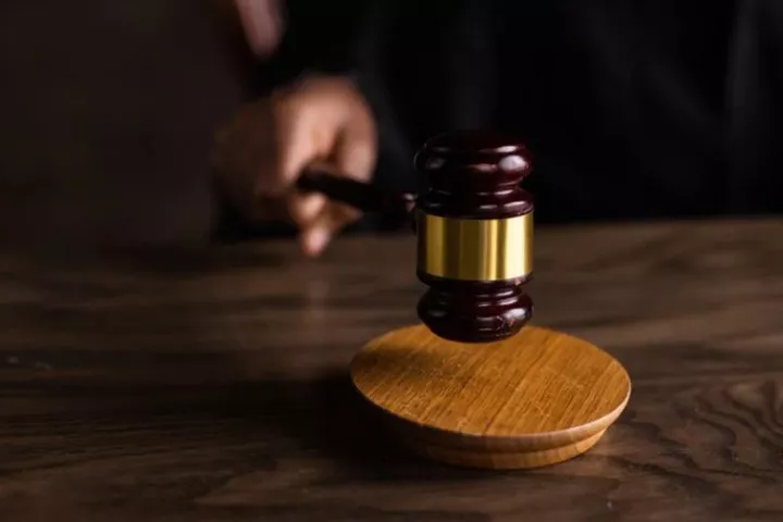 Judge striking a gavel on a wooden desk