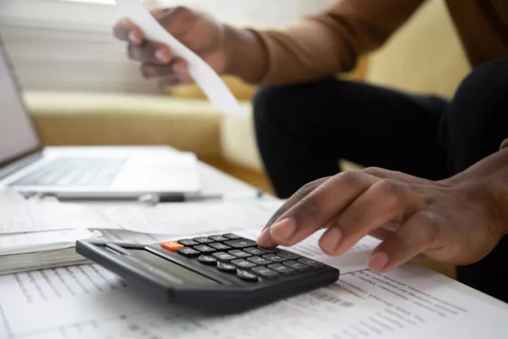 person with calculator and paperwork