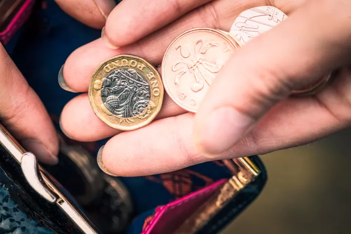 Person putting money into purse