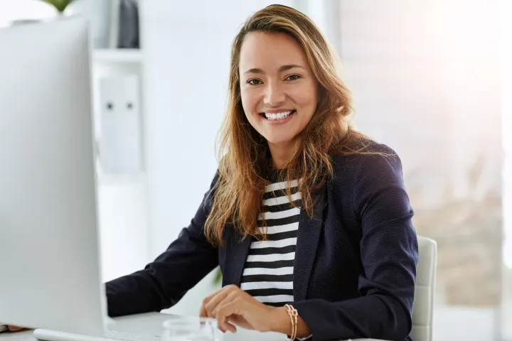 Woman wearing stripey top looking at computer