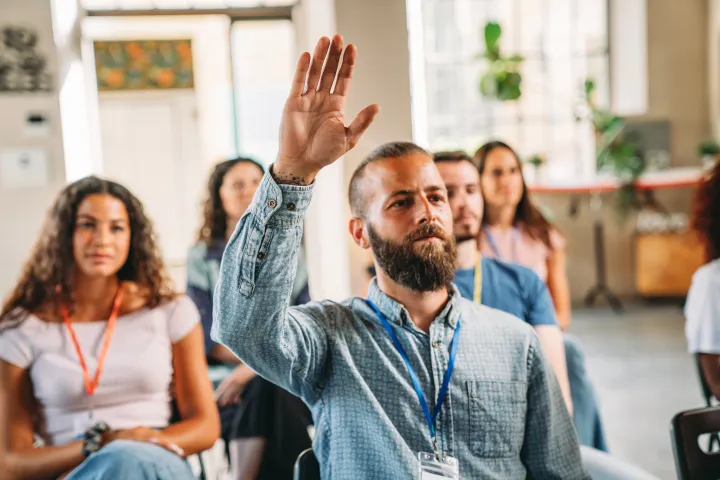 Man raising hand in classroom
