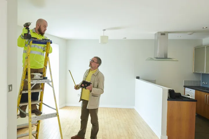 Contractor and landlord making final repairs stock photo