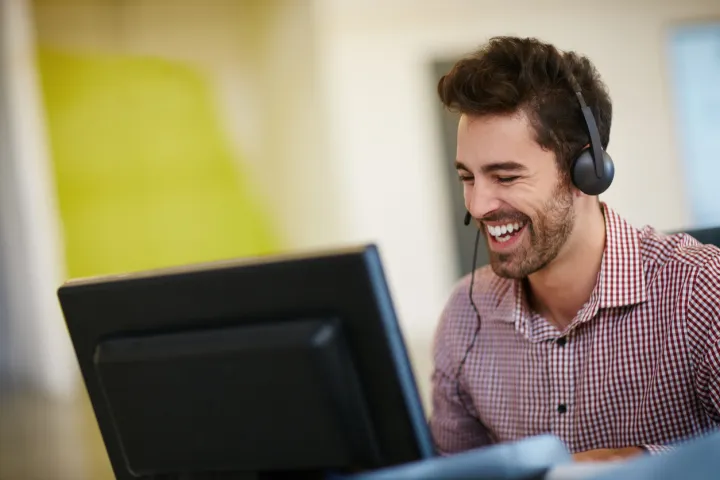 Man in front of computer wearing headset