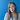 Kate McCauley, Housing Rights CEO standing in front of a blue background smiling