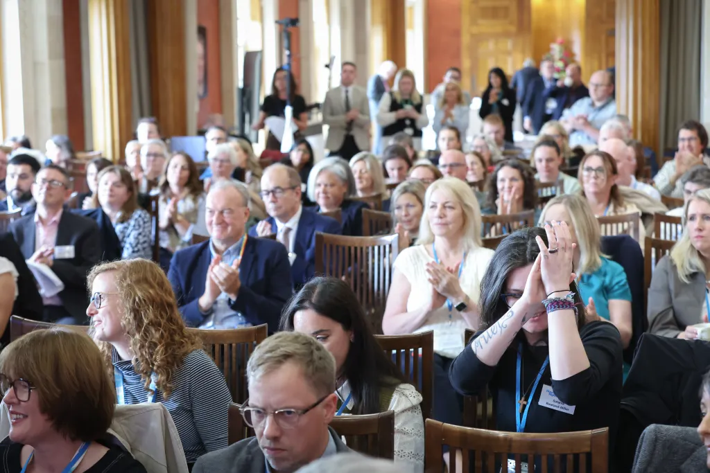 Crowd at event clap when hearing announcement from Gordon Lyons
