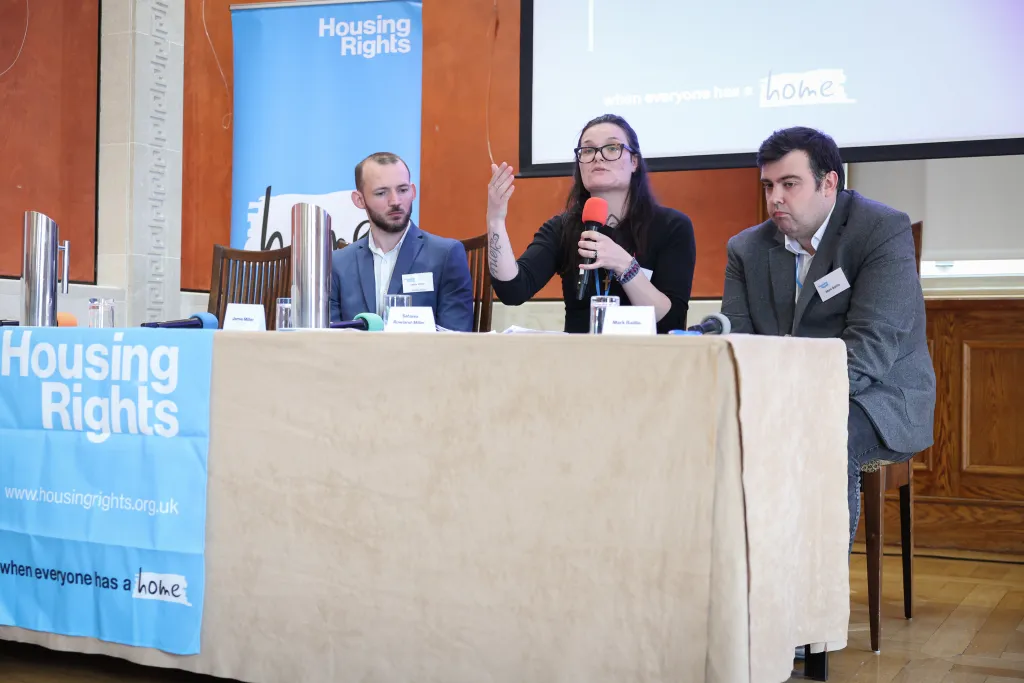 Panel of experts discuss topic. Expert by experience gestures with her hands
